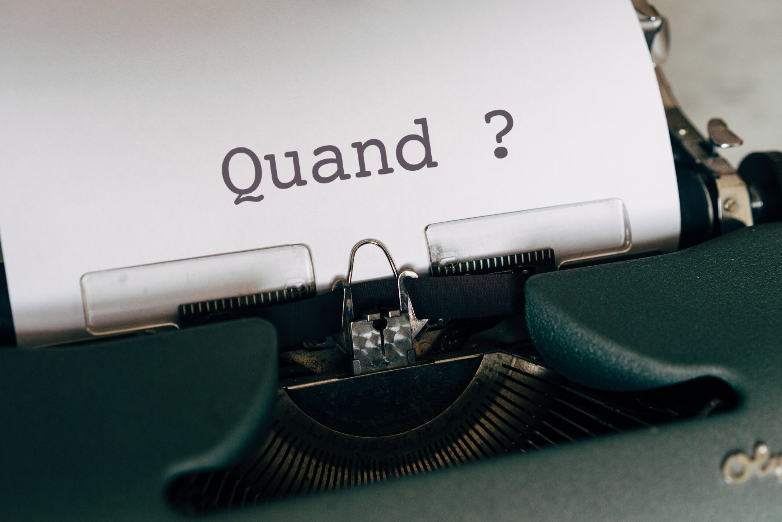 Machine à écrire avec sur le papier écrit "Quand ?"